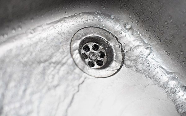 water flowing into sink drain