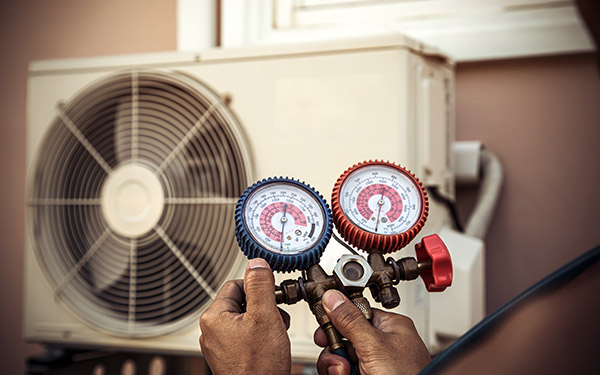 Technician checking HVAC unit